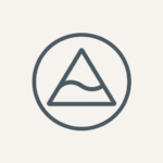 Icon of Circle with Triangle and a wave. Symbolically reflects the inner journey, the ripple effect of service, and emotional intelligence